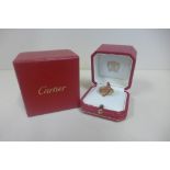 An 18ct yellow gold Cartier ring, fluted swept design set with Cartier signature, with ring box