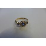 A sapphire and diamond, fully hallmarked 18ct gold ring, set with a pale blue sapphire approx 3mm