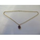 A 14ct yellow gold amethyst pendant on a modern 9ct chain, total weight approx 6 grams, pendant