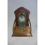 A brass and copper Art Nouveau mantle clock, 21cm tall, with replacement battery movement but with