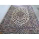A hand knotted woollen Persian rug, 395cm x 253cm