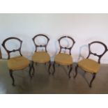 A set of four Victorian carved walnut framed and upholstered balloon back dining chairs - in sound