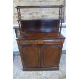 A 19th century rosewood chiffonier with a two tier waterfall top over a cushion drawer and two