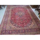 A hand knotted woollen rug, 352cm x 257cm