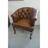 A leather button back tub shaped armchair, 81cm tall x 69cm wide