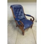A 19th century scroll arm button back blue leather library chair on turned front legs, sound