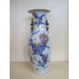 A large Chinese 19th century porcelain vase decorated with Fu dogs in an iron red and blue glaze, in