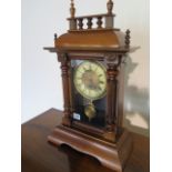 A Victorian mixed wood/glazed pendulum mantle clock with brass and enamel face - running in saleroom