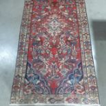 A hand knotted woollen Hamadan rug - 198cm x 98cm