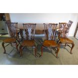 A good quality Stewart Linford oak drop leaf dining table and six fan back elm seated chairs in good