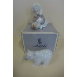 A Lladro Eskimo boy and polar bear, boxed - and a Lladro polar bear - both good