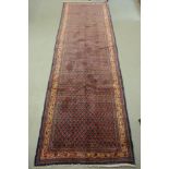 A hand knotted woollen Araak rug - 320cm x 107cm