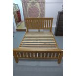 An ex-display oak 5 foot bed, no mattress