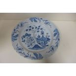 A Delft ware plate, 30cm diameter, fritting to edge and crazing but generally good