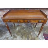 An early 19th century mahogany two drawer side table on turned legs and brass castors, 84cm tall x