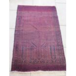 A hand knotted woollen Antique Baluchi rug - 150x98cm