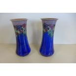 A large pair of 24cm royal Doulton vases decorated with a floral and fruit design by Maude Bowden,