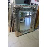 A modern ornate silvered mirror with beveled edged glass, 120cm 95cm