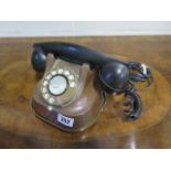 An antique copper and Bakelite telephone, probably Belgian