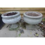 A near pair of stone effect urns, 36cm tall