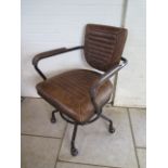 An Angela Reid distressed leather swivel desk chair