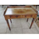 A 19th century mahogany writing table with two drawers on turned legs, 90cm wide, 75cm High, 48cm