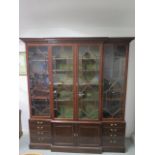An impressive 19th century mahogany breakfront book case, with a four door astragel one piece top