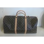 A Louis Vuitton leather trimmed holdall, with a suede interior, 50cm long, 25cm x 29cm - with some