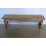 A rustic pine bench, 142cm wide
