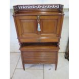 A late Victorian Asthetic period walnut bureau cabinet with a stylised gallery above a fall front
