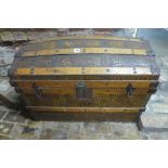 A late Victorian faux crocodile skin dome top trunk with wooden banding, 59cm tall x 84cm x 50cm -