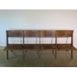 A good quality early four seater 20th century oak church bench which can fold flat, 210cm - in sound