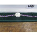 A boxed ladies sterling silver and amethyst quartz wristwatch, running