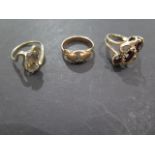 Three 9ct gold rings, garnet set, smokey quartz set and rose gold with a small green stone, sizes N,