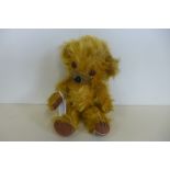 A Merrythought 'Cheeky' bear circa 1950 - 26cm tall, foot label intact, Bells in ears, small seam