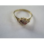 An 18ct hallmarked diamond and ruby ring, size O, approx 2.5 grams, generally good, diamonds bright,