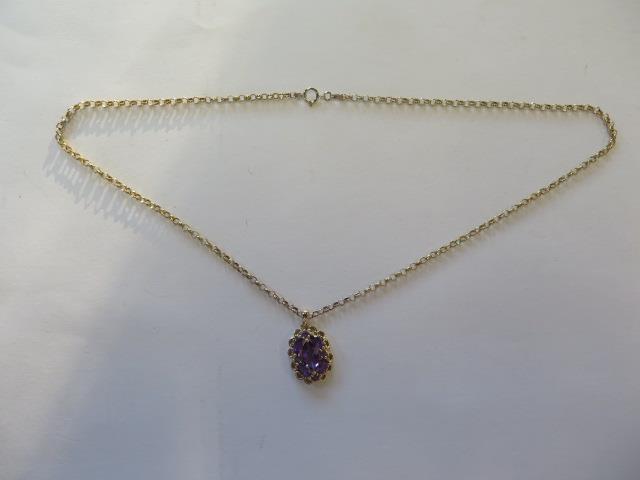 A 14ct yellow gold amethyst pendant on a modern 9ct chain, total weight approx 6 grams, pendant