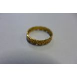 A hallmarked decorative 22ct yellow gold band ring, size P, approx 3 grams, some wear consistent