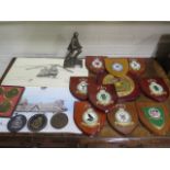A collection of military/RAF heraldic shields, signed prints, coaster and bronzed figure