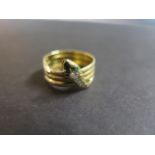 An 18ct yellow gold snake ring, quadruple looped band with head and tail detail, the head set with