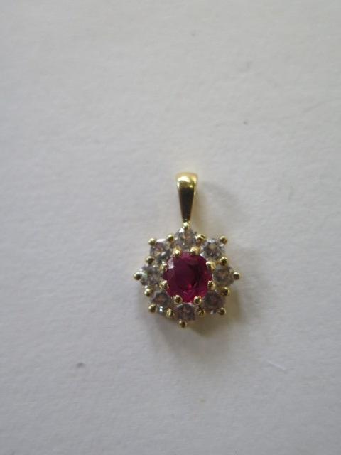 A hallmarked diamond and ruby pendant, 10mm wide, diamond approx 0.46ct, ruby approx 0.39ct - approx