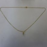 An 18ct yellow gold diamond solitaire, 0.25ct approx pendant on chain - in generally good condition