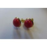 A pair of 18ct coral set earrings, marked 750, approx 2.9 grams, 10mm diameter, generally good