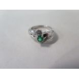 An 18ct white gold emerald and diamond ring, size N, approx 4.5 grams, some general usage marks,
