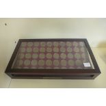 A collection of sixty Britannia pennies of the 20th century, with corresponding date cards, in a