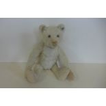 A white Steiff bear, 30cm tall, button in ear, issued 1905 to 1950 - this bear is probably 1920's,