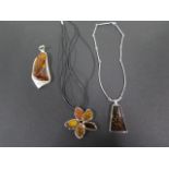 Three white metal and amber necklaces, test as silver, largest 8.5x3.5 cm - total weight approx 81.9