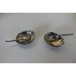 A pair of sterling silver shell salts and spoons, 5cm wide, approx 1.3 troy oz, in good condition
