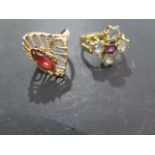 Two 18ct gold dress rings, one with red stones, size M 1/2 - the second with an amethyst and four