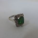 An 18ct white gold diamond and green stone ring, size M/N, approx 4.9 grams, overall generally good,